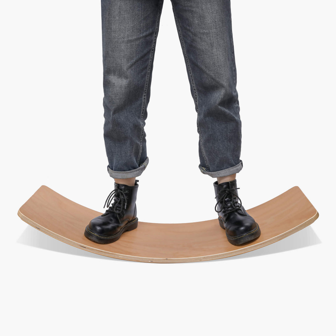 person standing on balance board for desk