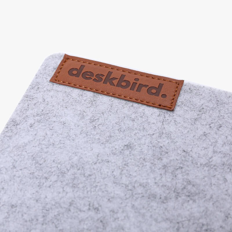close up of deskbird logo on desk pad